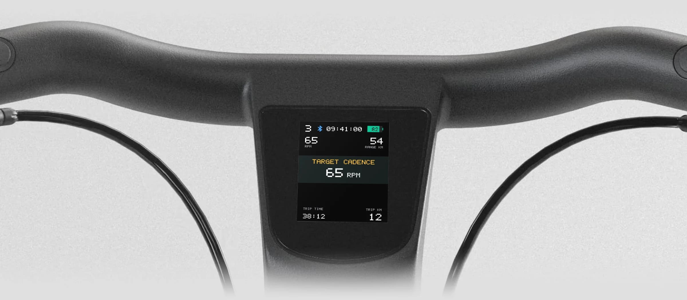 Handlebar display showing a target cadence of 65 RPM